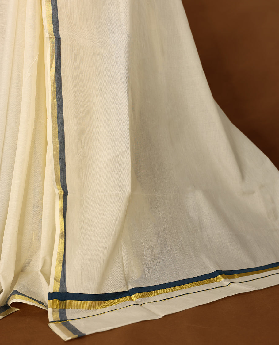 Elegant off white colour cotton Kerala saree featuring a plain body and traditional golden zari border with a hint of Midnight Blue, offering a classic and graceful look, paired with a matching blouse.