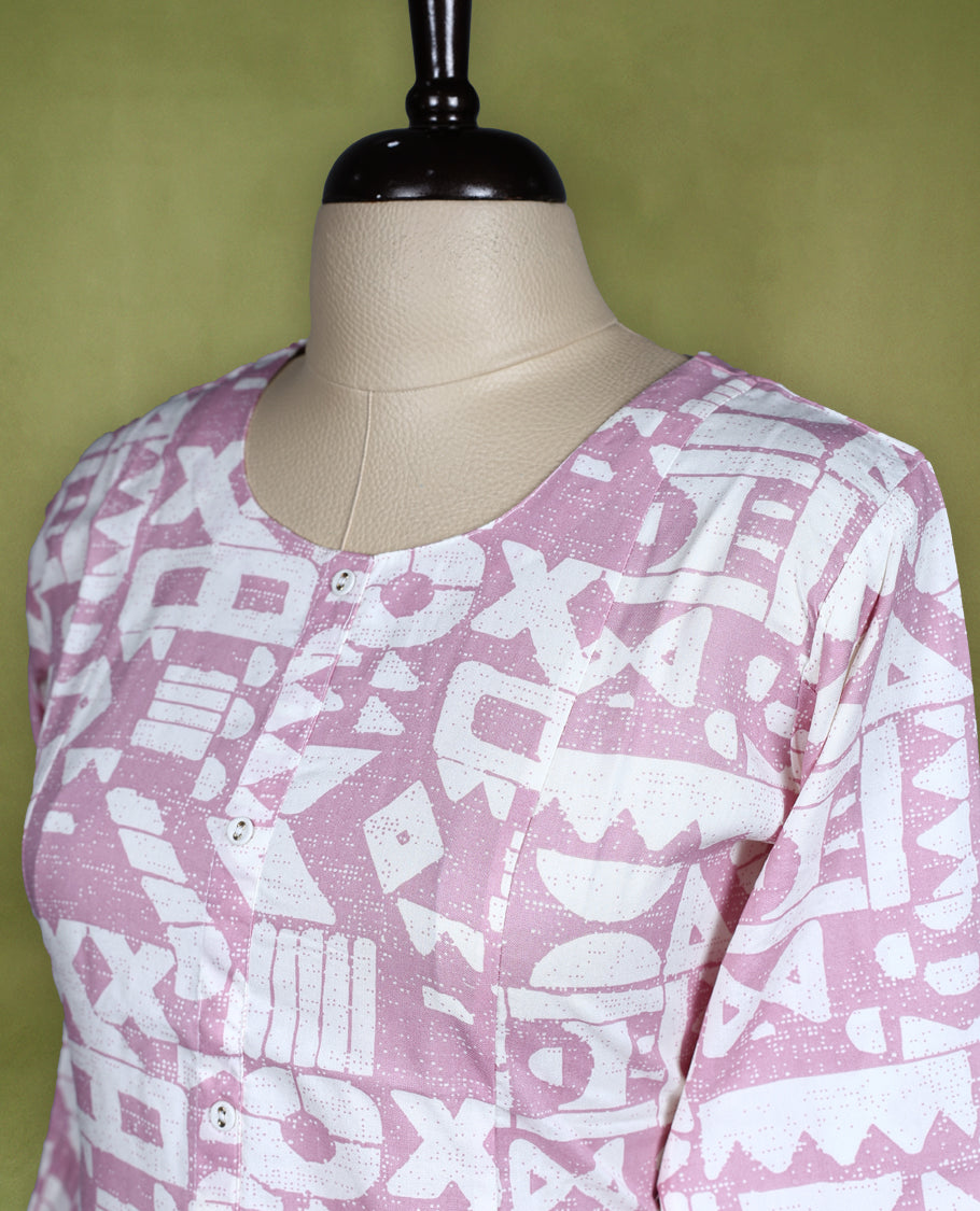Soft mauve and white printed kurti with abstract geometric patterns, styled with a round neckline, front button placket, and 3/4th sleeves, ideal for smart casual or daily wear.