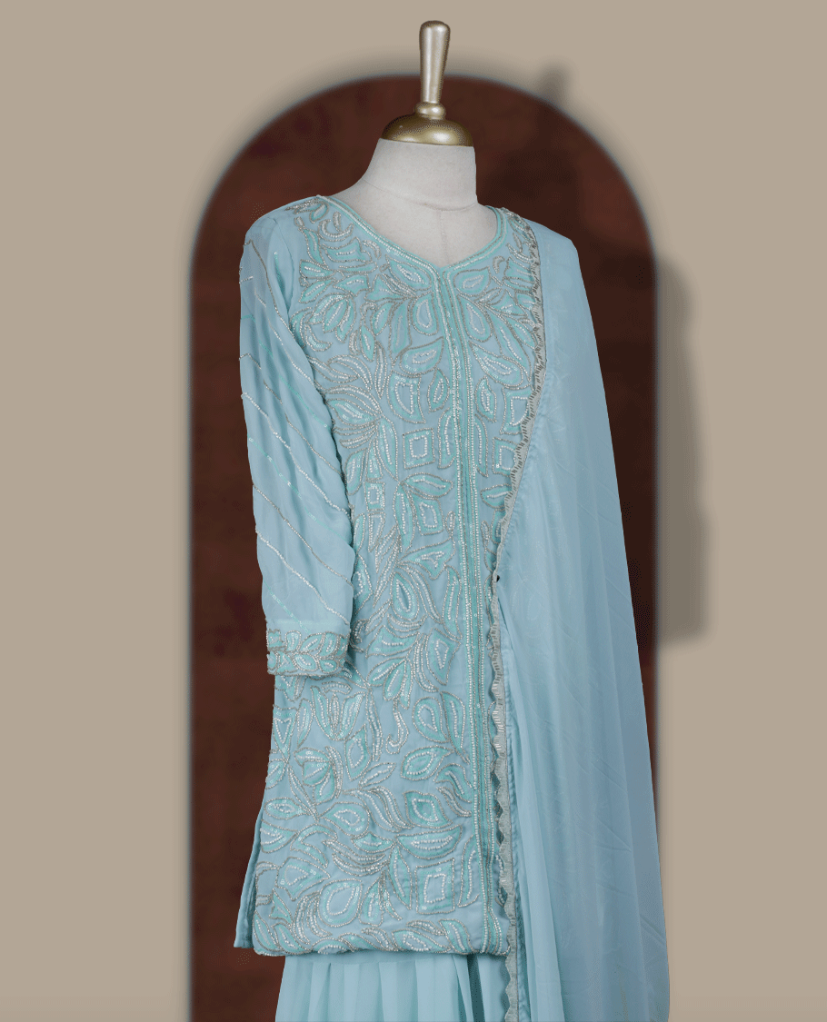 Elegant Ice blue colour embroidered sharara set featuring intricate sequins and cut beads work, paired with a soft matching dupatta edged with delicate detailing and a beautifully flared bottom for a graceful festive look.