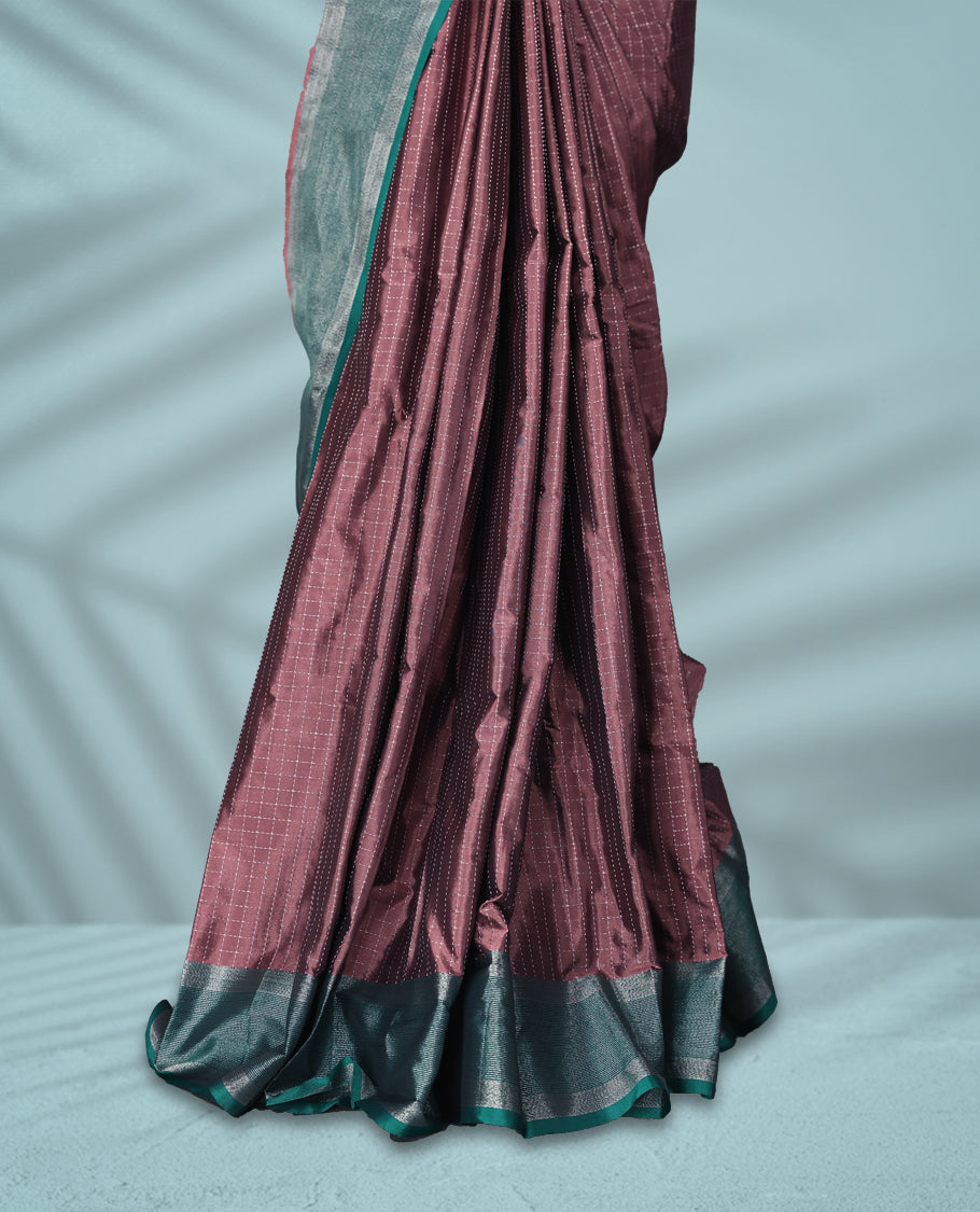 Pastel Brown colour body with delicate silver checks, paired with a contrasting green and silver zari border, comes with a matching blouse.