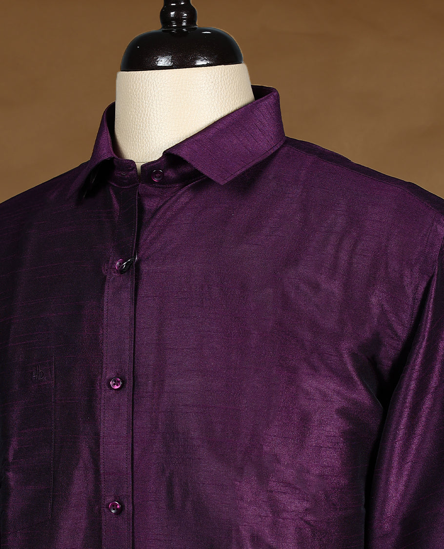 Rich wine purple colour men’s shirt in a relaxed formal fit, crafted with a glossy self textured finish, full sleeves, classic collar, and chest pocket ideal for festive or evening wear.