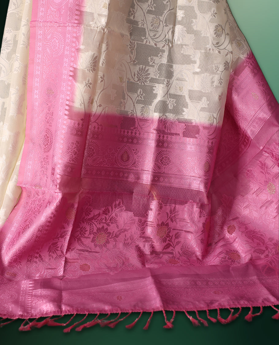 White colour saree adorned with delicate self woven motifs across the body, highlighted with a striking Pink woven border and pallu, finished with tassels, and paired with a matching blouse