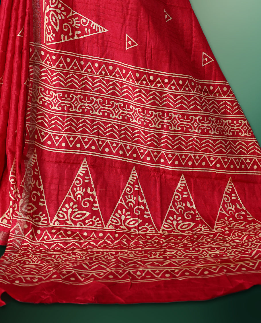 Red Colour saree featuring bold geometric and ethnic inspired prints all over the body, enhanced with a matching printed border, complemented by a striking patterned pallu, and paired with a matching blouse