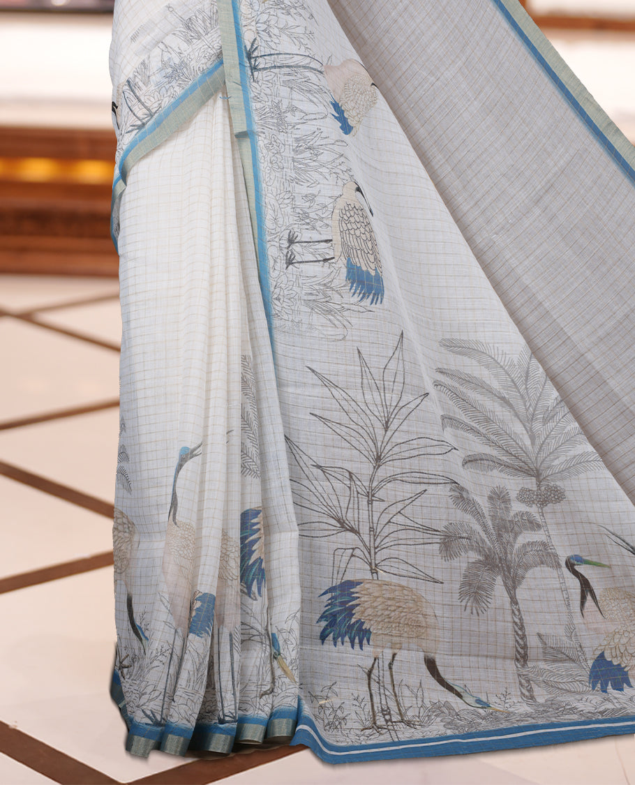 Off white colour Soft cotton saree featuring elegant bird prints along the edges, a stylish checked body, and a beautifully designed blue border & Paired with a matching blouse piece.