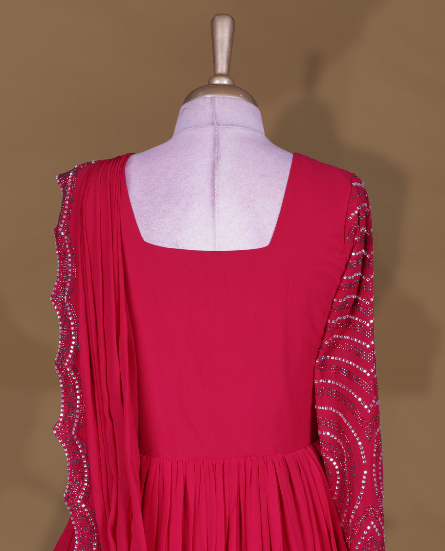 Rani pink colour stitched gown set with square neckline, attached pleated flare, and one‑side draped dupatta highlighted with heavy silver sequin and mirror work border and sleeve.