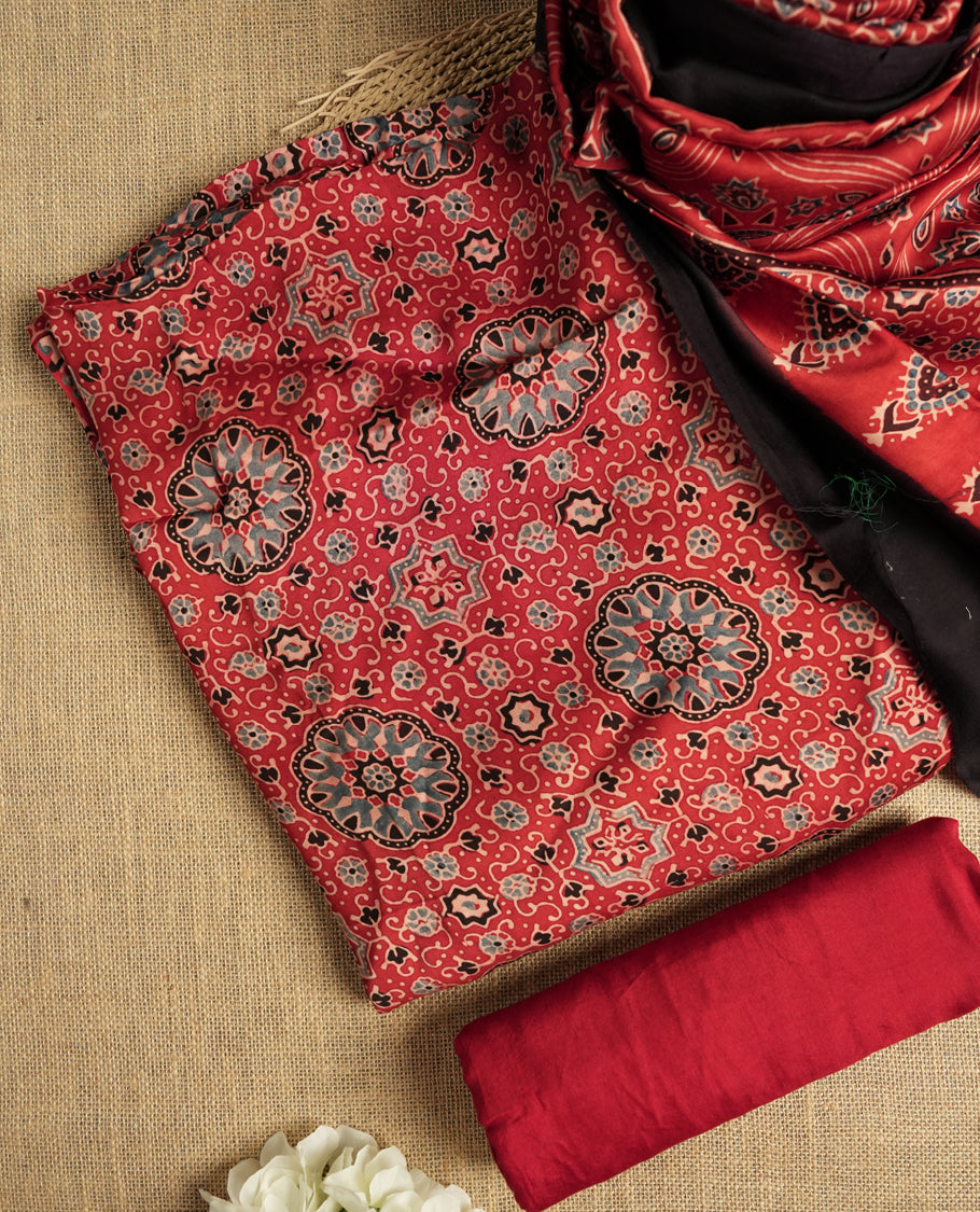 Rich Maroon colour suit material featuring traditional Ajrakh inspired prints in black and beige hues & Paired with a beautifully patterned dupatta and solid matching bottom.