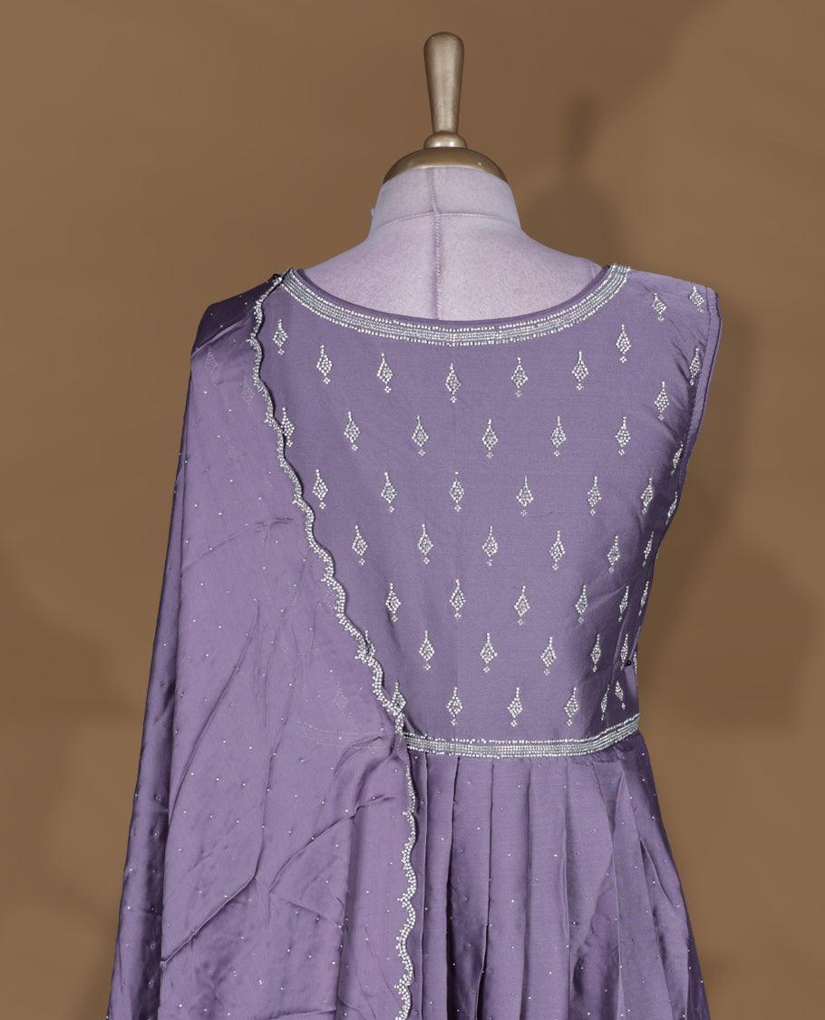 Dusty purple colour stitched gown set with sleeveless embroidered yoke, flared ankle‑length silhouette, and attached dupatta edged with scalloped beadwork and matching embroidered hem.