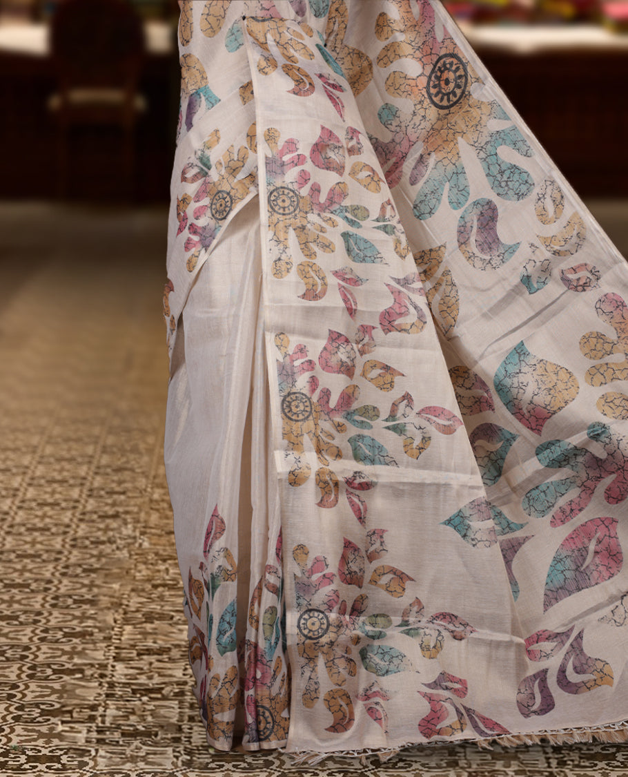 Beige colour Semi tissue saree adorned with Multi colour digital Leaf Design on the body and an elegant pallu & comes with a matching blouse piece
