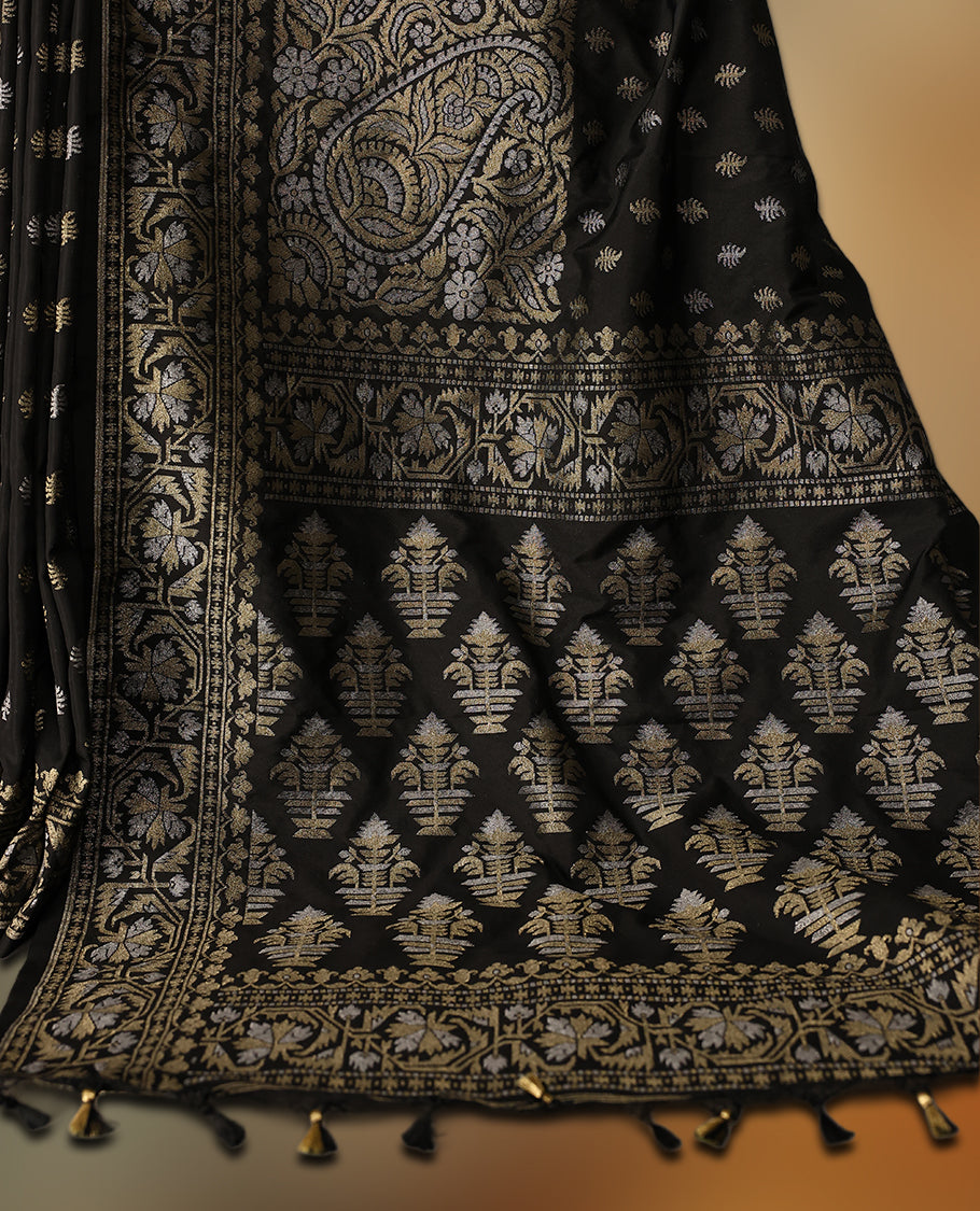 Elegant black Banaras soft silk saree with gold zari buttas on the body, ornate floral zari border, rich woven pallu, and comes with a matching blouse & A timeless drape for festive and formal occasions.