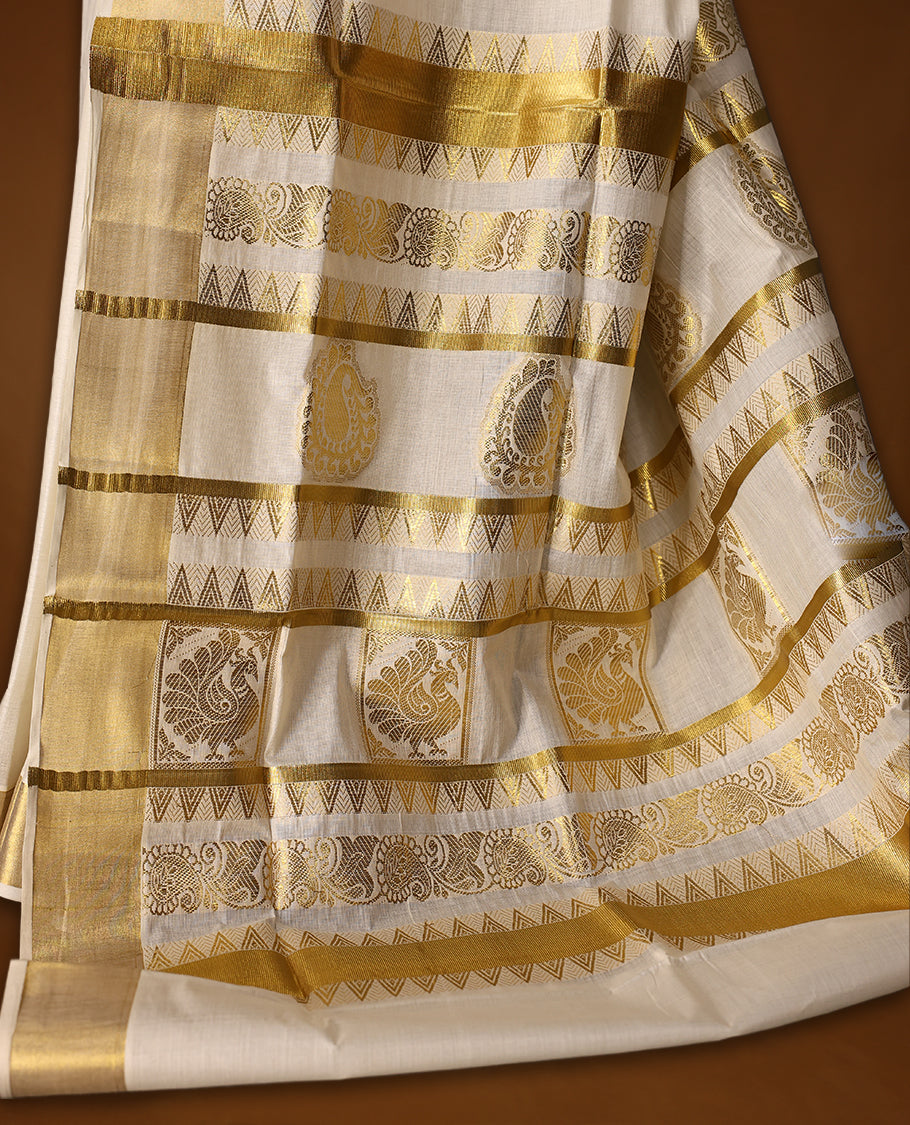 Graceful Kerala Kasavu saree with golden zari motifs and richly woven pallu, the ivory base and elegant border make it perfect for festive and traditional occasions, Pair with temple jewelry for a classic look.
