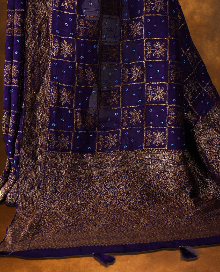 Indigo Banarasi Bandhani saree with golden zari motifs in checkered Bandhani body, detailed zari woven border, and rich pallu with tassels. A perfect blend of tradition and festive grace.