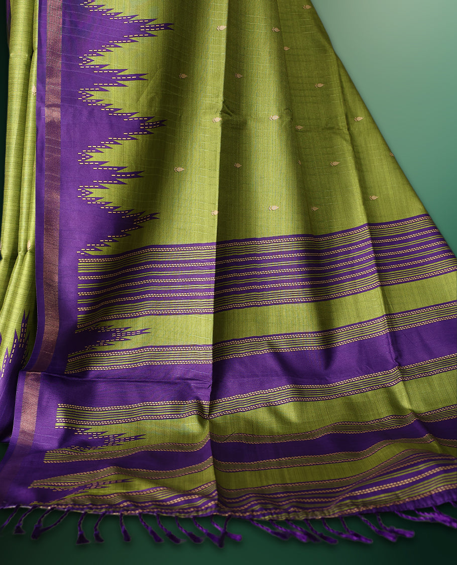 Green colour saree adorned with subtle woven motifs on the body, enhanced with a striking Purple Temple patterned border, complemented by a rich Purple striped pallu with tassels, and paired with a matching blouse