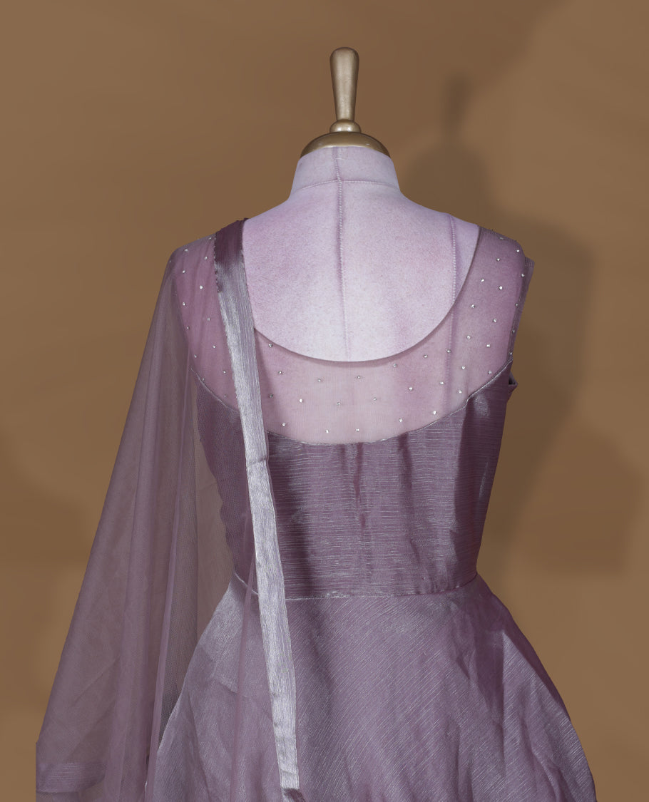 Dusty mauve colour stitched gown set with sleeveless embellished yoke, sheer studded back, flared layered hem with scalloped edge, and matching plain sheer dupatta.
