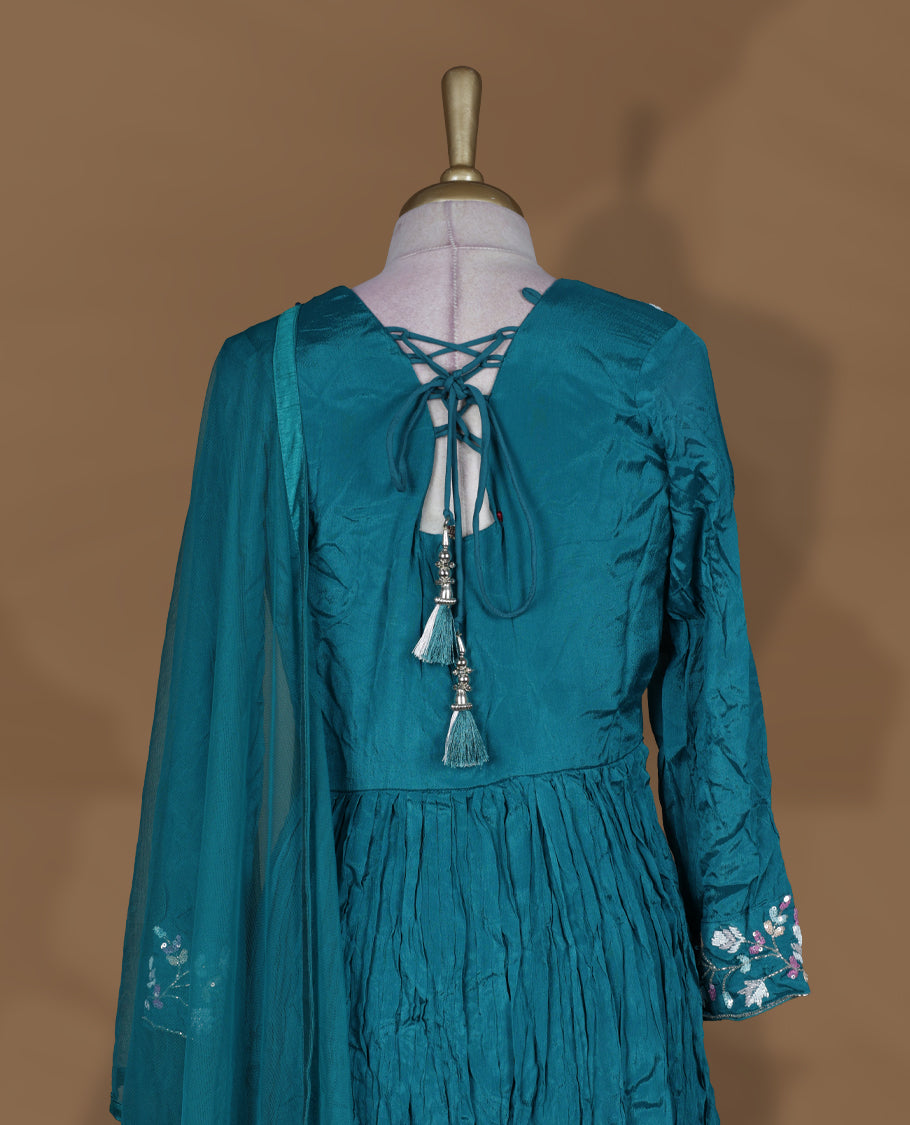 Teal green colour stitched gown set with V‑neck floral embroidered yoke, gathered flare, full sleeves with cuff embroidery, and matching plain sheer dupatta.