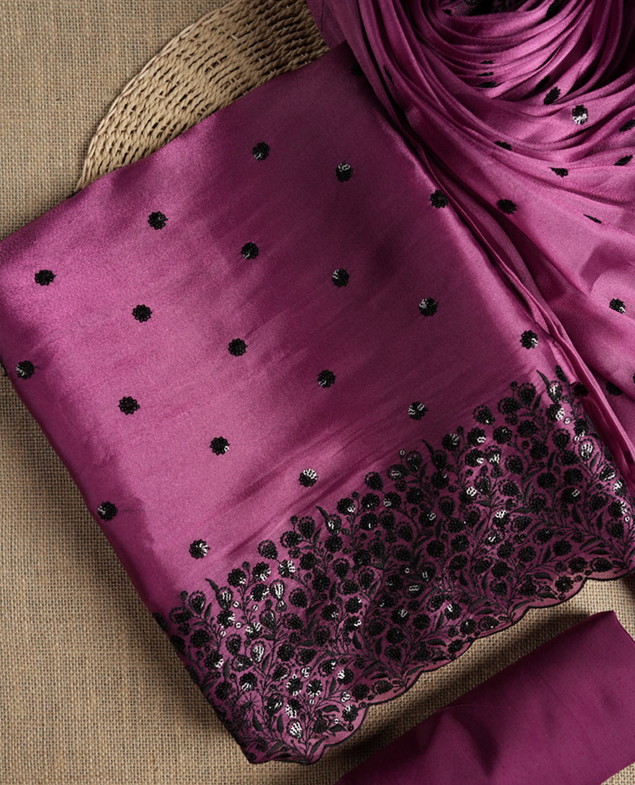 Elegant Mulberry pink colour suit material adorned with black sequin embroidery and floral lace border. Comes with a matching dupatta featuring elegant embroidered motifs and a plain bottom