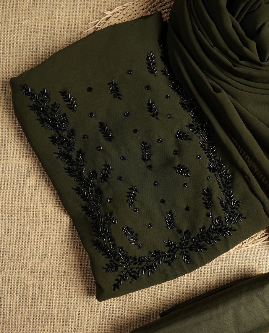 Dark Olive green colour suit material adorned with intricate black cut beads work, exuding sophisticated charm & paired with a soft dupatta and a matching plain bottom.