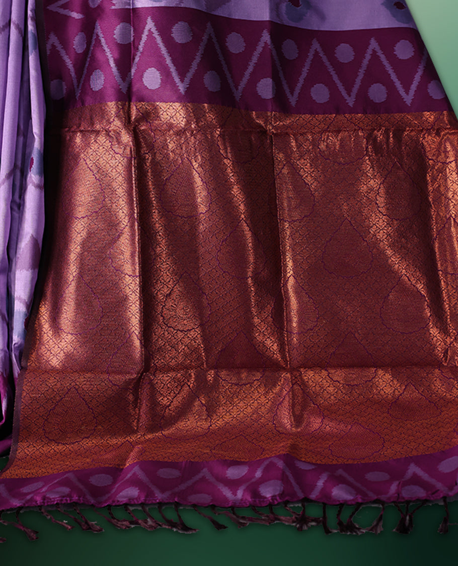 Lavender colour saree featuring subtle woven motifs on the body, enhanced with a deep Purple geometric patterned border, complemented by a rich zari pallu with tassels, and paired with a matching blouse