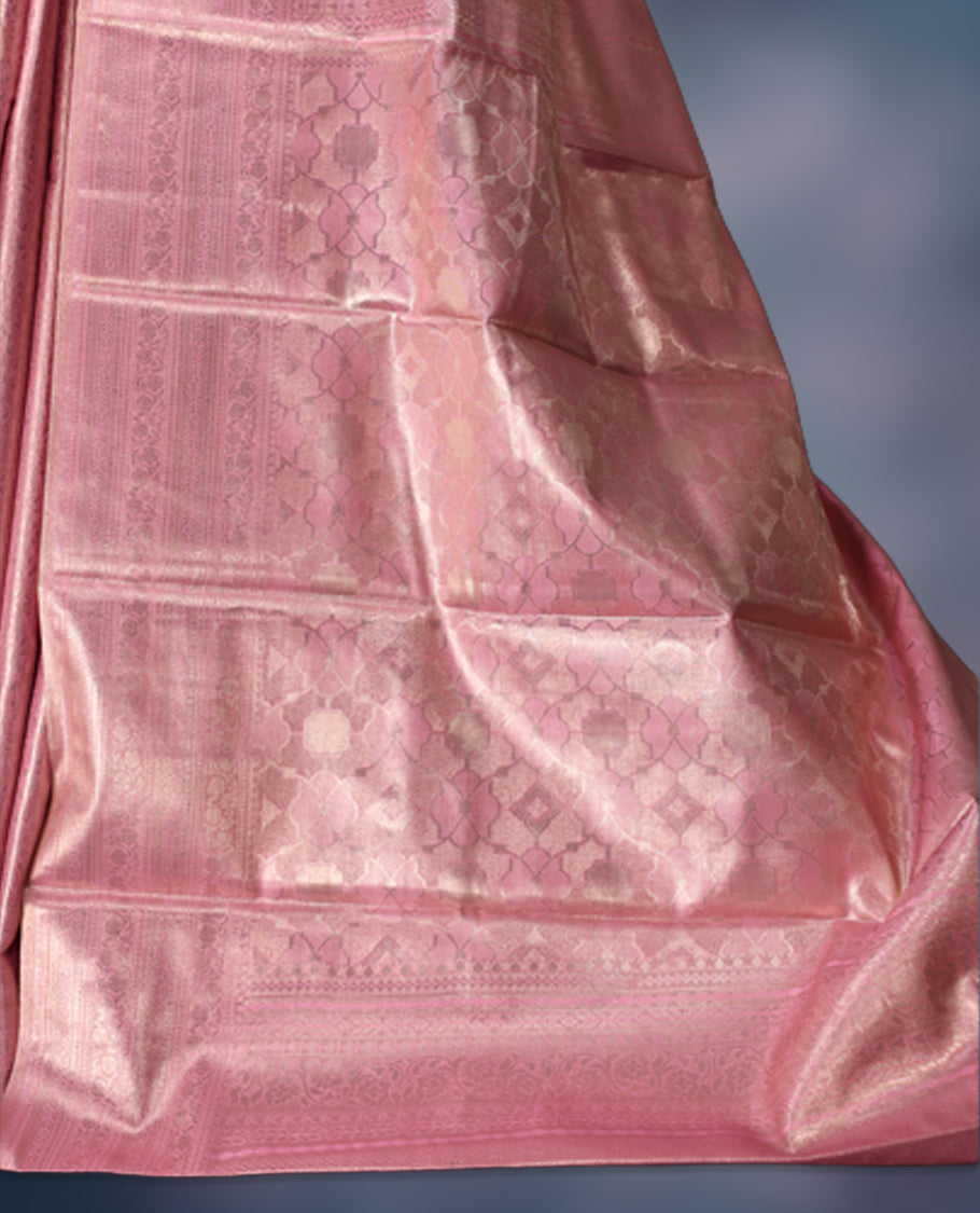 Baby pink colour semi silk brocade saree featuring delicate self design brocade patterns across the body, complemented by a rich self colour woven border and pallu, paired with a matching blouse.