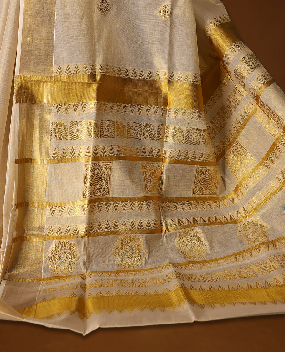 Classic Kerala Kasavu saree with golden motifs and a grand woven pallu, The ivory tone with intricate zari detailing makes it ideal for weddings and festivals, Pair with gold jewelry for a graceful, regal look.
