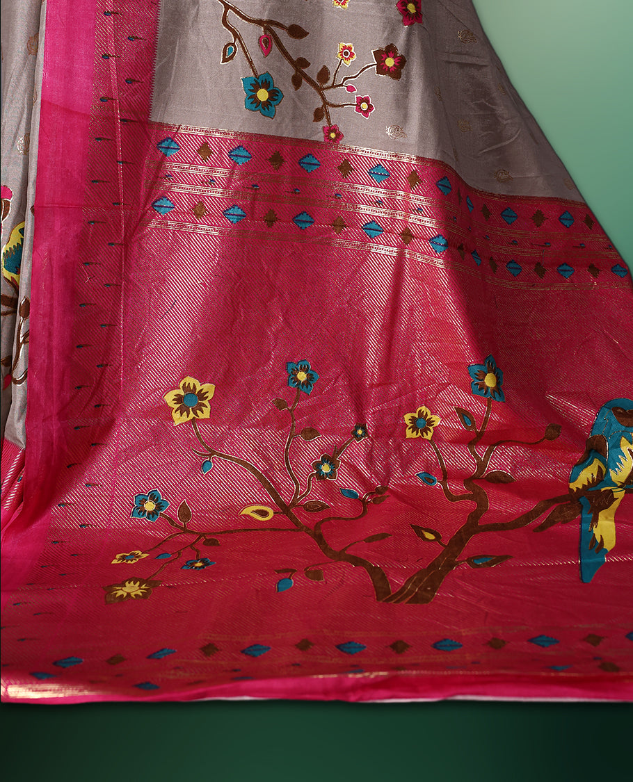 Grey colour saree adorned with delicate woven motifs on the body, enhanced with a vibrant Pink border, complemented by a colourful printed pallu featuring floral and bird designs, and paired with a matching blouse