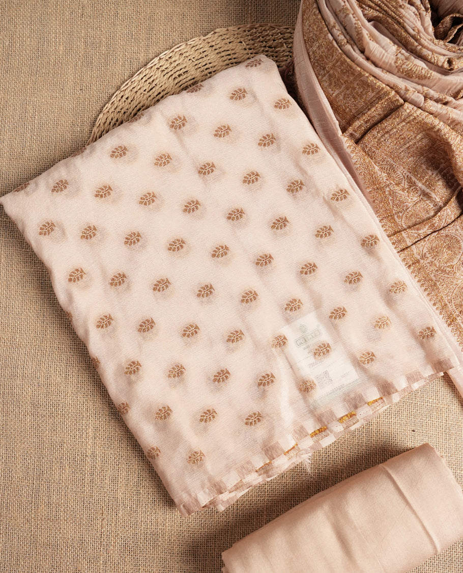 Elegant beige colour suit material adorned with subtle golden designs, exuding timeless charm & Paired with a beautifully woven dupatta and a matching plain bottom.