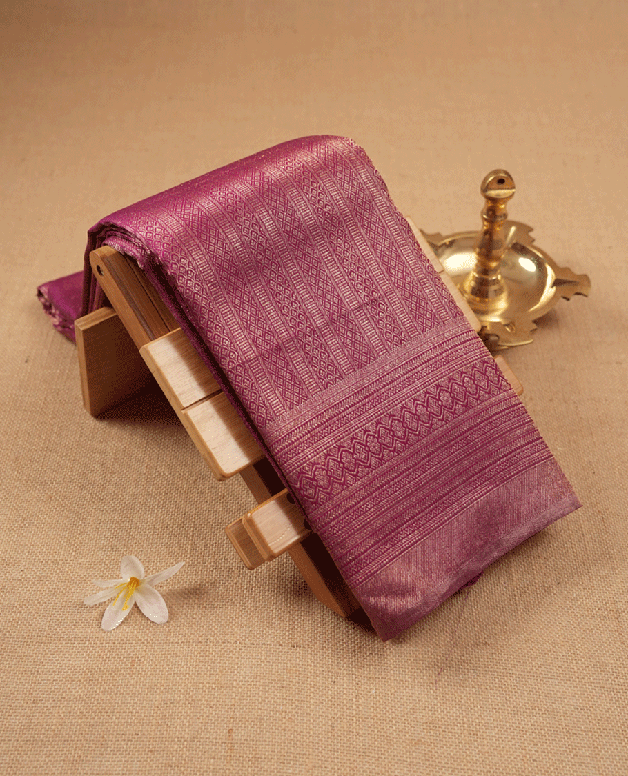 Grape wine Colour Manthrakodi saree featuring an antique zari brocade body, complemented by a self coloured traditional border and a matching self coloured brocade blouse.