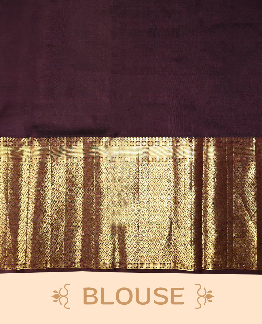 Muted mauve Colour traditional Kancheepuram silk saree adorned with antique zari traditional motifs on the body, featuring a contrasting border with Rich floral and geometric patterns, and paired with a matching blouse.
