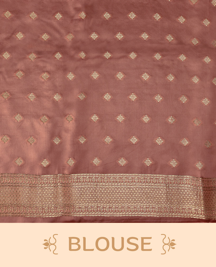 Pastel brown colour pure Banaras crepe saree showcases elegant Gold zari Flower Motifs all over the body, a traditional gold & Silver zari border, a rich intricately woven pallu, and comes with a matching blouse.