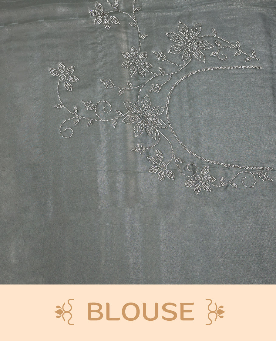 Light Pastel Green colour net shimmer fancy saree adorned with subtle horizontal White stone patterns on the body, paired with a delicate stone worked border, with matching blouse