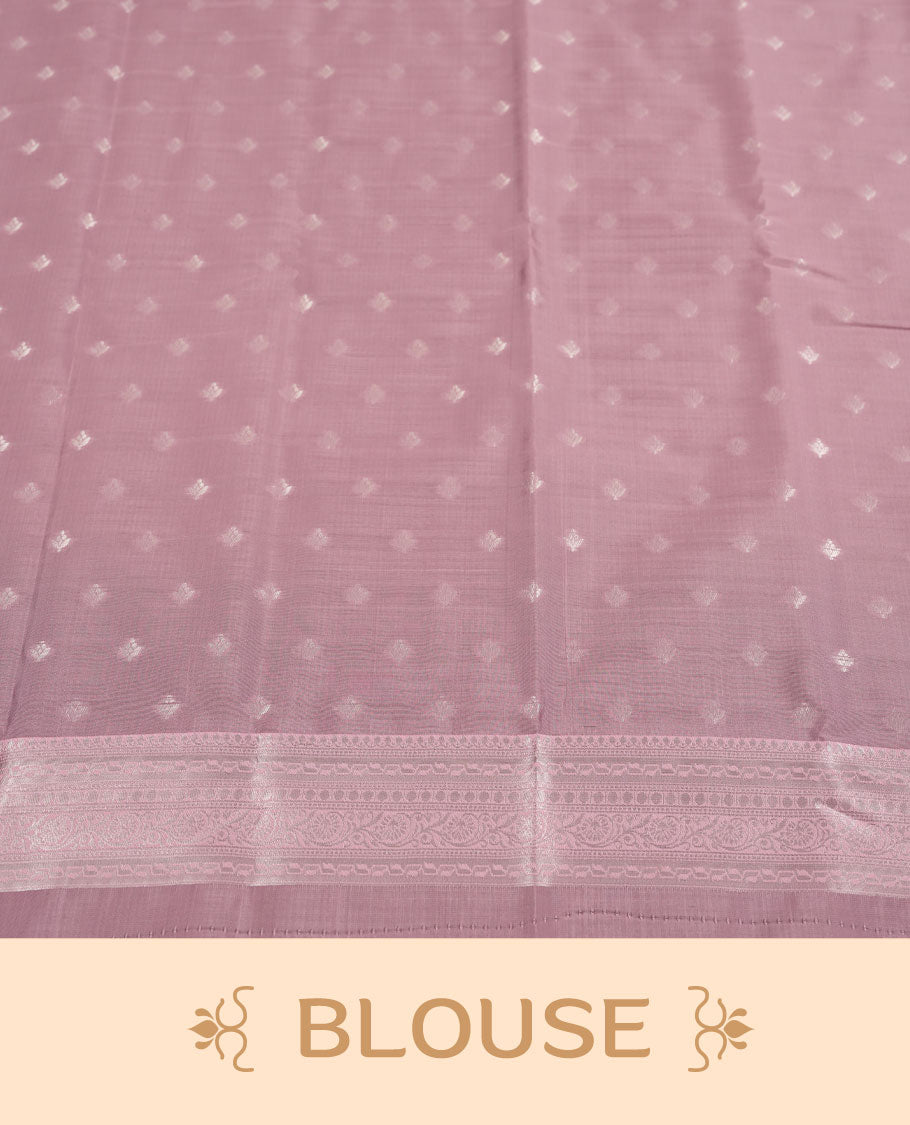 Navy blue colour semi silk saree adorned with subtle silver floral patterns on the body, complemented by contrasted a pastel light pink pallu intricately  woven with rich floral patterns border and pallu, and paired with a matching blouse