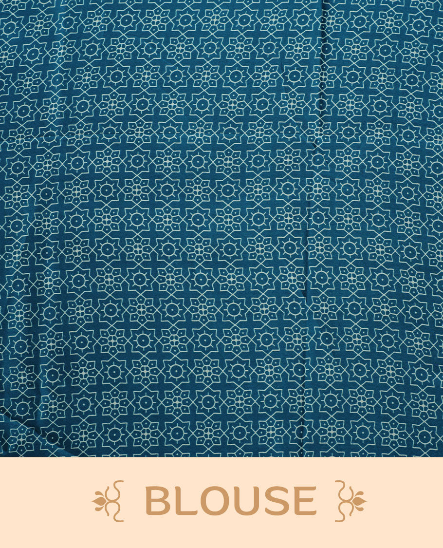 Teal Blue colour semi modal saree featuring bold white geometric borders and fine stripe detailing, finished with an oversized white circular motif on the pallu, paired with a matching printed blouse.