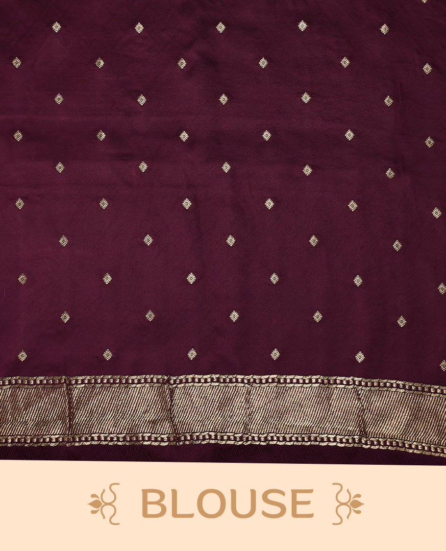 Maroon colour crepe Banaras saree featuring small zari Floral Motifs across the body, without border, a sleek texture, and a rich golden zari pallu with geometric patterns, paired with a matching blouse for a graceful festive look