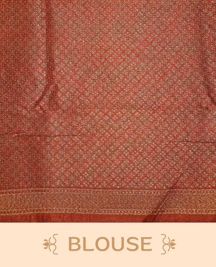 Rust Orange colour Tussar Banaras saree adorned with delicate golden zari motifs on the body, rich floral woven zari border and grand pallu, paired with a matching blouse for an elegant and regal traditional look.