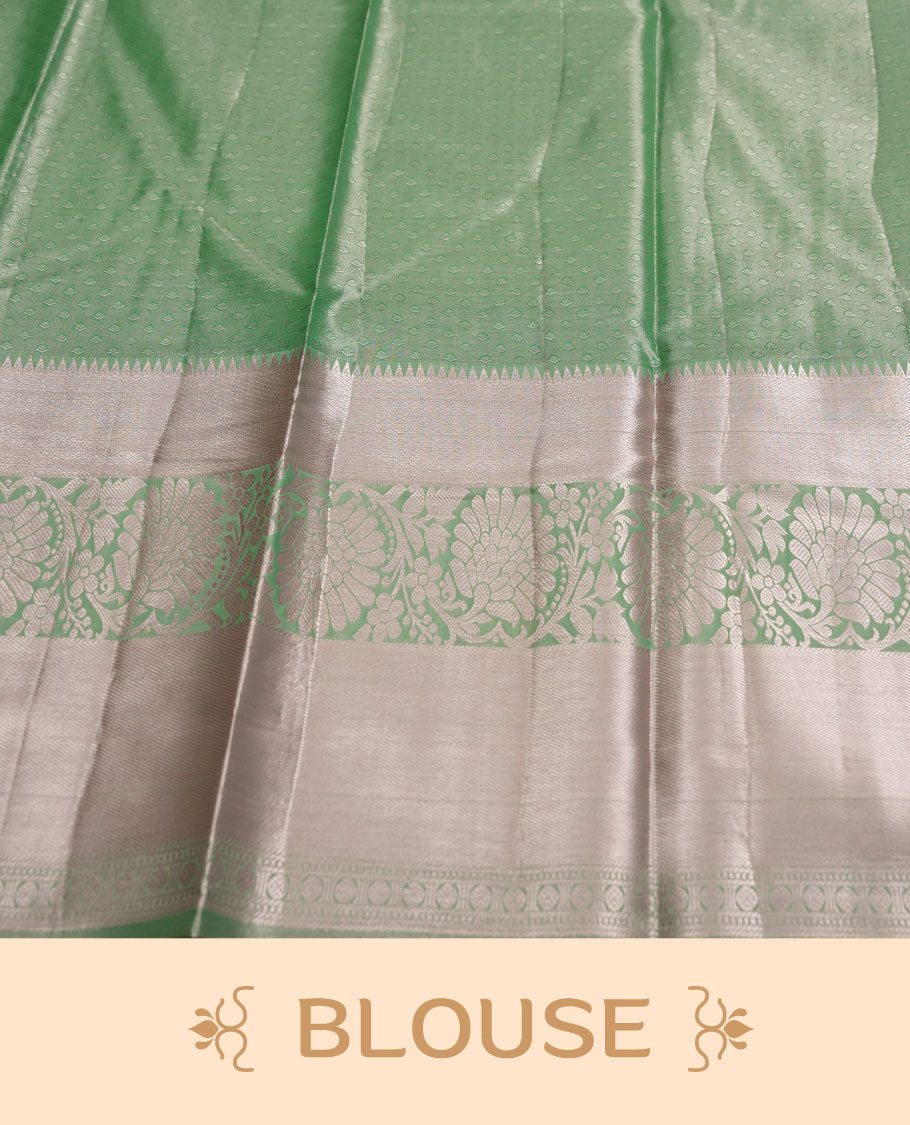 Pastel green colour and Antique gold Zari Tissue Brocade Saree features intricate floral Motifs on body and light rose gold border & pallu with floral patterns, paired with matching blouse