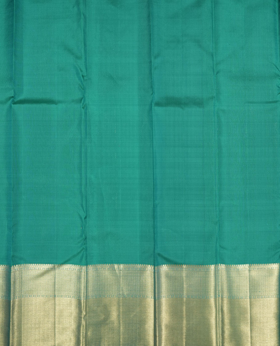 Turquoise blue colour Kanchipuram pattern Manthrakodi saree featuring golden zari box jacquard with small zari motifs across the body, traditional zari border, zigzag bavanji detailing, and plain zari blouse piece.
