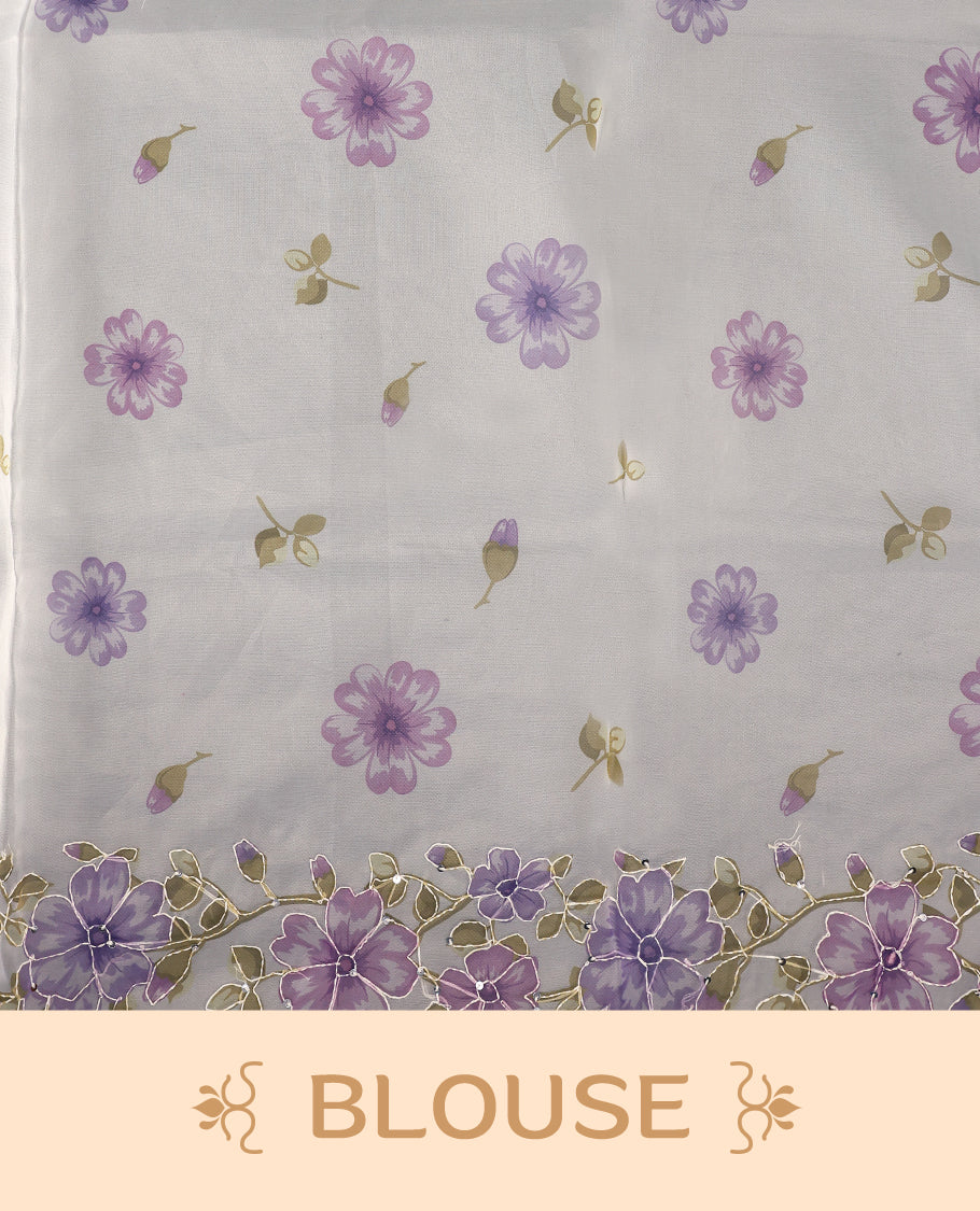 Ivory white colour organza saree adorned with purple floral print with thread detailing on the border and pallu, in a sheer finish that adds elegance, paired with a matching blouse for a graceful look.