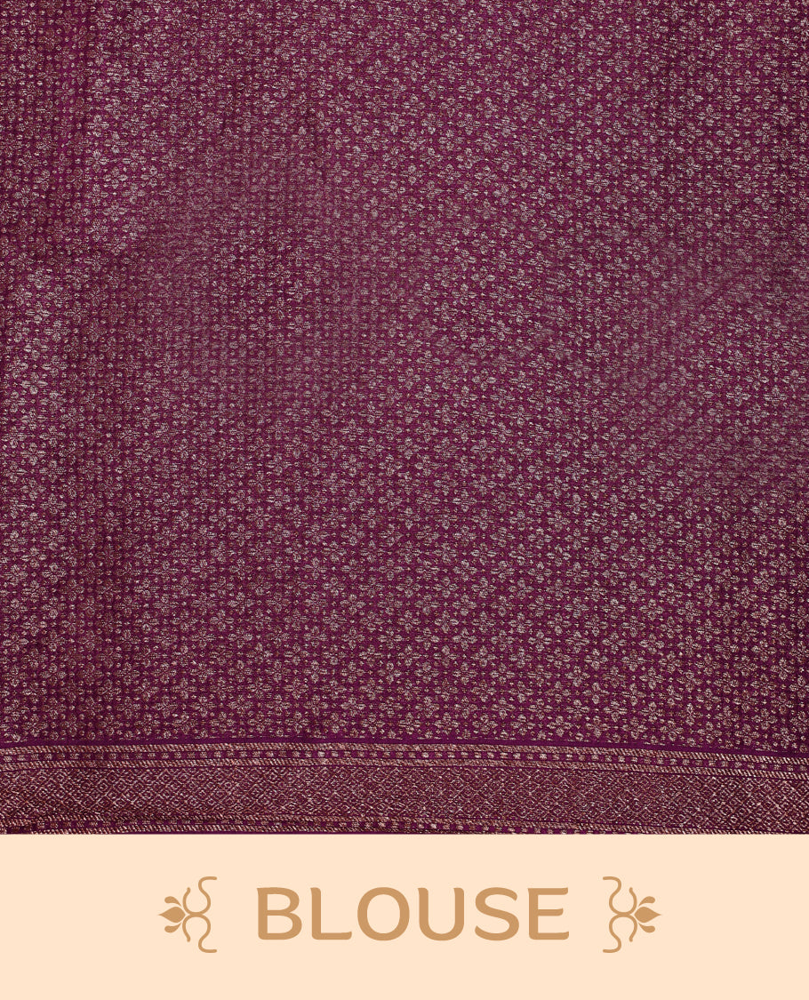 Grape wine colour Tussar Banaras saree adorned with delicate golden zari motifs on the body, rich floral woven zari border and grand pallu, paired with a matching blouse for an elegant and regal traditional look.