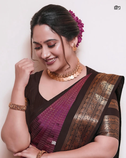 Dark Brown and Dark Pinkish Maroon Colour pure Kancheepuram silk saree featuring gold zari elephant & floral brocade border, body with gold checkered patterns and Gold & Silver colour Peacock Motifs, traditional pallu paired with matching blouse