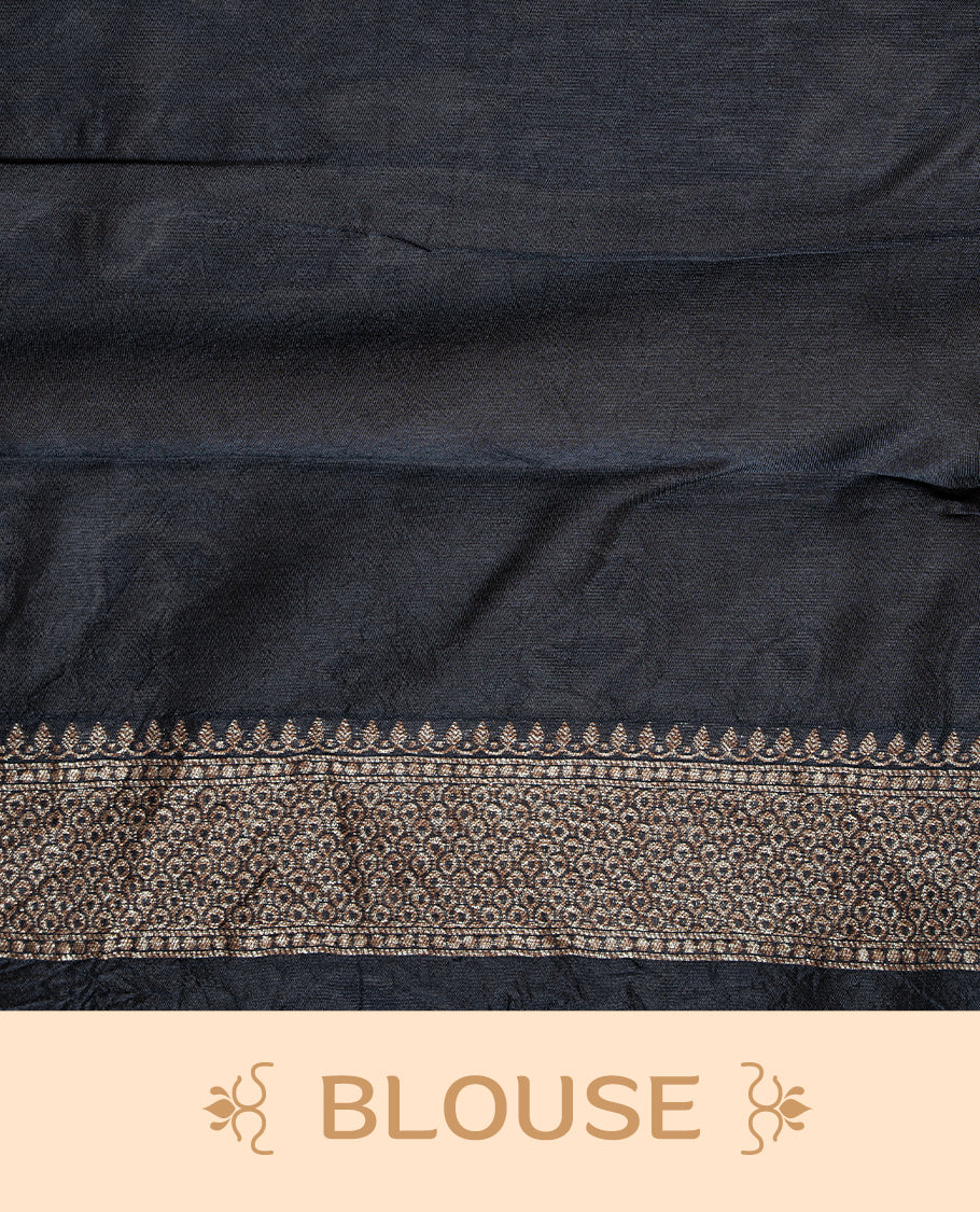 Black colour Semi Banaras Tussar Georgette Featuring Gold zari Leaf pattern on body, Finished with Gold zari border and paired with matching blouse piece.
