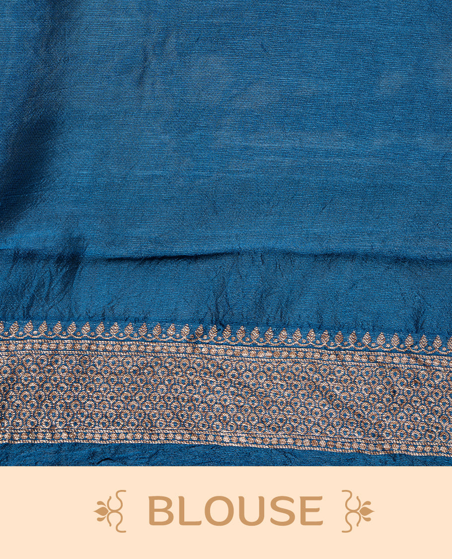 Blue colour Semi Banaras Tussar Georgette Featuring Gold zari Leaf pattern on body, Finished with Gold zari border and paired with matching blouse piece.