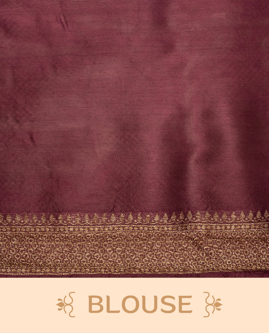 Burgundy colour Semi Banaras Tussar Georgette Featuring Gold zari Leaf pattern on body, Finished with Gold zari border and paired with matching blouse piece.