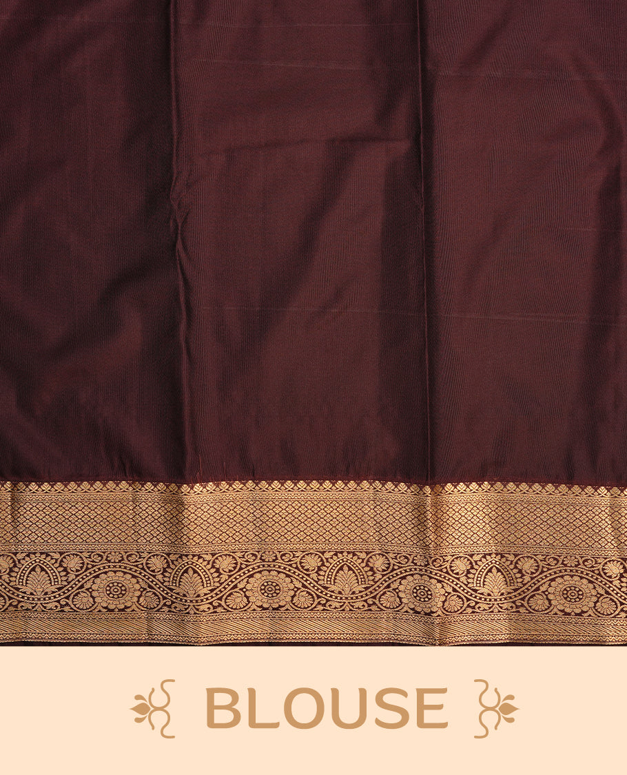 Orange colour semi wedding saree featuring gold zari floral kode pattern on body, contrast chococlate colour with traditional border, paired with matching blouse piece.