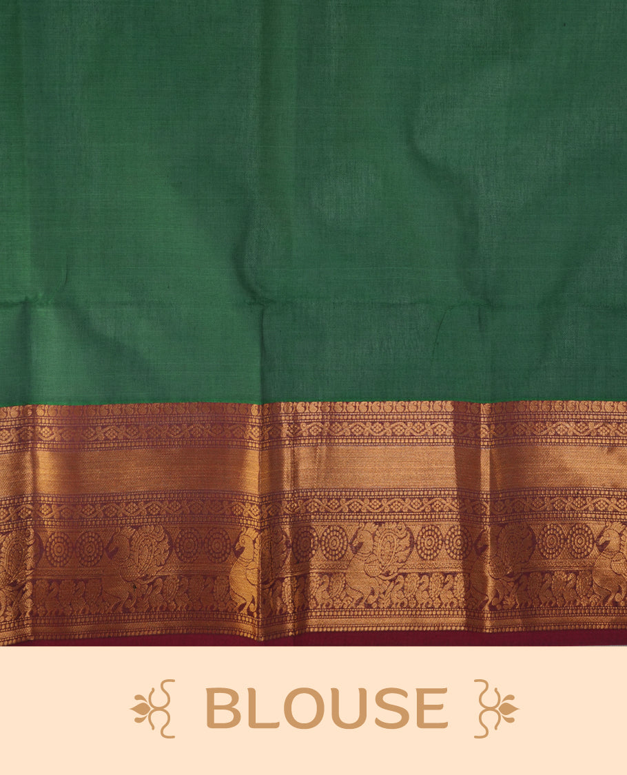 Green colour chettinad saree featuring gold zari stripes on body, complemented by contrast maroon colour with traditional border, paired with matching blouse piece.