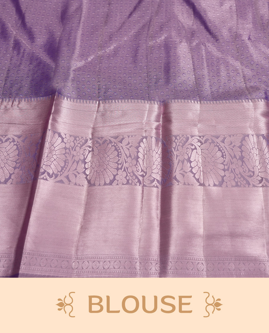 Lavender colour and Antique silver Zari Tissue Brocade Saree features intricate a navy blue coloured floral Motifs on body and A rose gold traditional border & pallu with floral patterns, paired with matching blouse