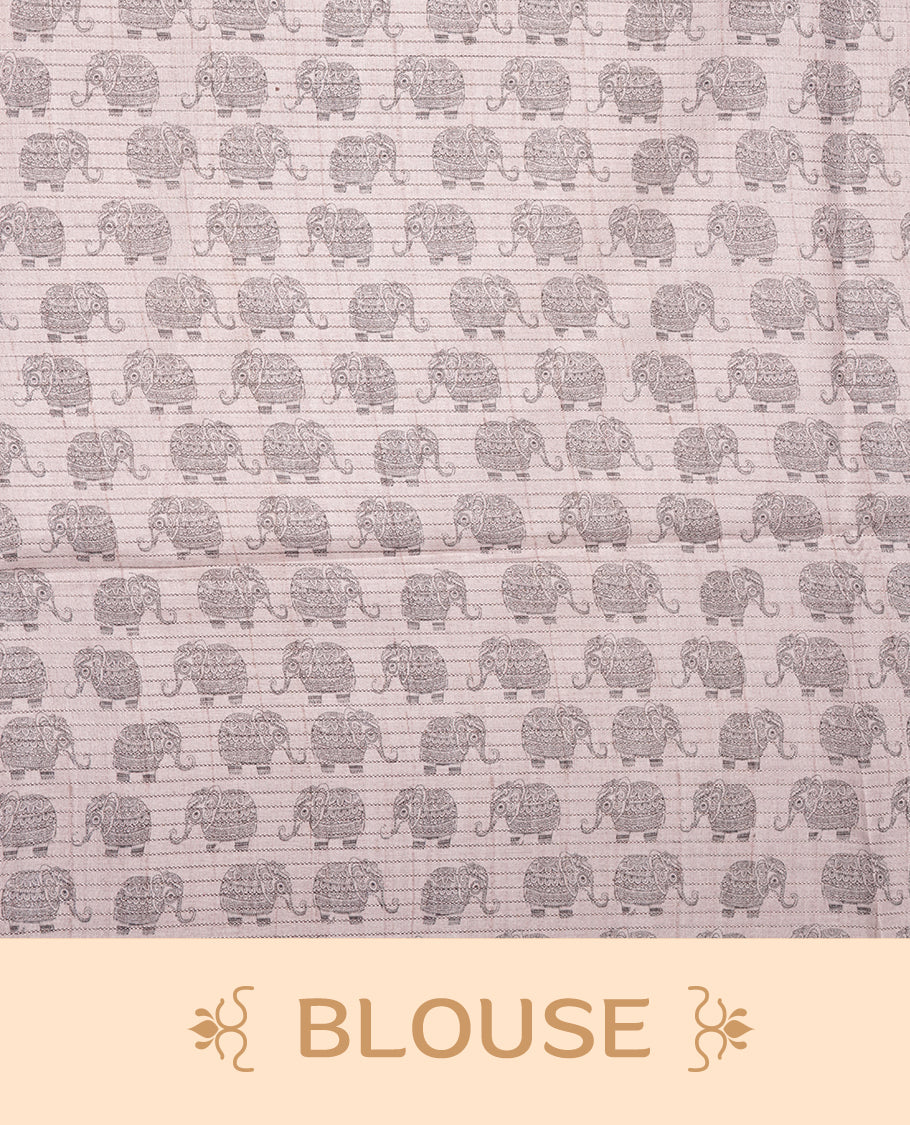 Charcoal green colour semi tussar silk saree featuring an all-over elephant motif print across the body, complemented by a contrasting blue pallu and border, and paired with a matching blouse piece.