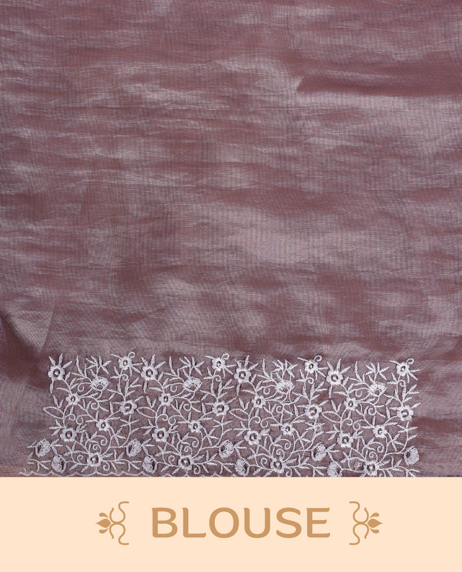 Light purple colour net organza designer saree featuring a subtle self patterned body and an intricately scalloped floral thread embroidered border all around, complemented by a coordinating embroidered pallu and paired with a matching blouse.