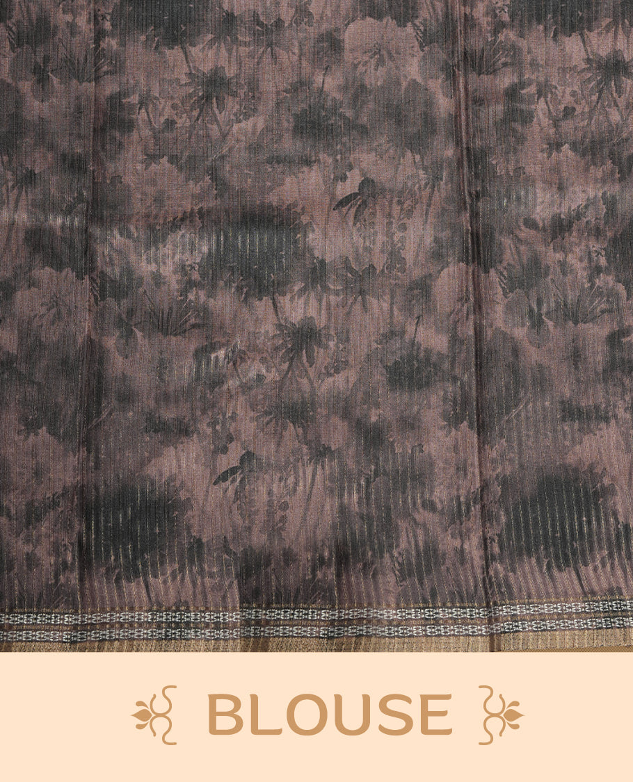 Smoky grey colour semi tussar silk saree featuring an abstract digital floral printed body, finished with a rich self border and tasselled pallu, paired with a matching blouse.