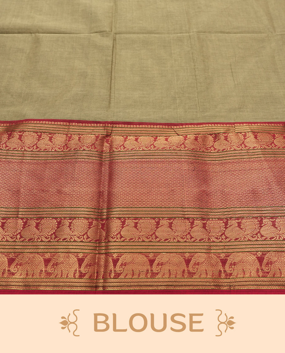 Olive Grey Colour silk cotton saree with broad temple-red zari border featuring peacocks and elephant motifs, subtle gold-striped pallu, and a plain olive grey blouse with the same rich zari border.