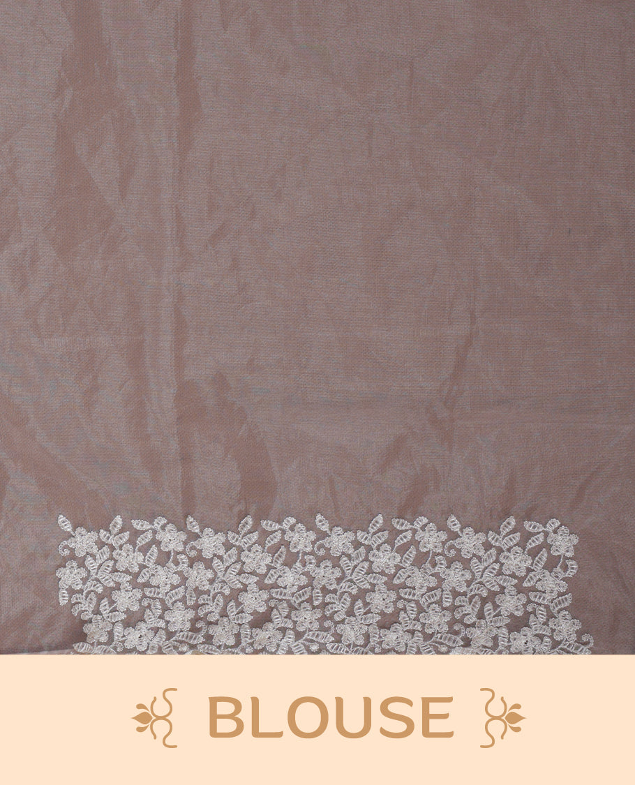 Cream colour organza designer saree featuring a subtle self patterned body and an intricately scalloped floral thread embroidered border all around, complemented by a coordinating embroidered pallu and paired with a matching blouse.