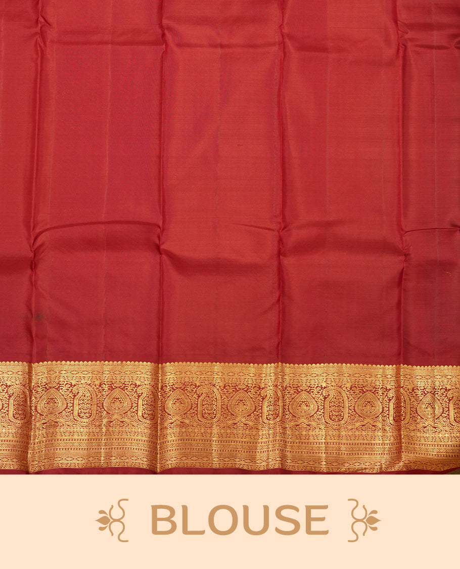 Green colour Vasundhara silk saree adorned with all-over gold mayil motifs on the body, complemented by a  contrast maroon colour with gold traditional border and paired with a matching blouse piece.